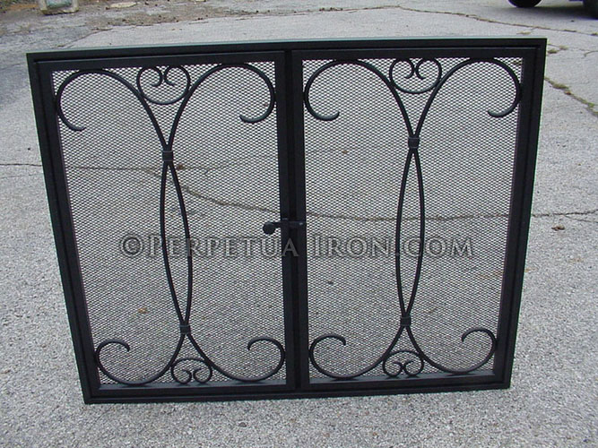Rectangular black frame fireplace screen with airy, vertical scroll work design using a steel mesh fire screen doors.