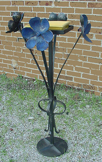 decorative iron plant stand with flower design