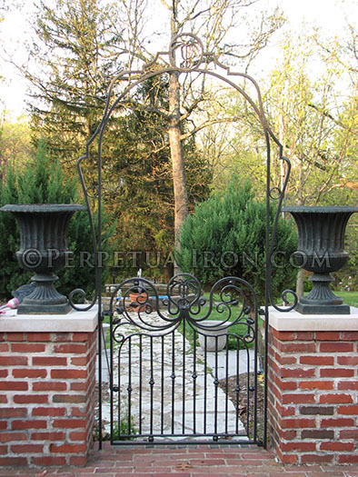 Decorative iron garden gate with arch.