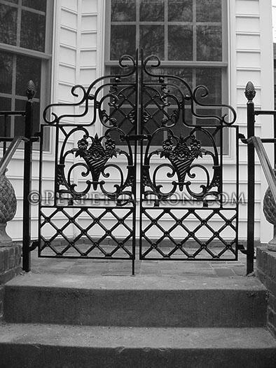 Iron court yard gate, cast iron design components, hand formed scrolls.