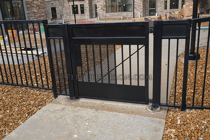 Iron gate with solid panels for commercial site secuity.
