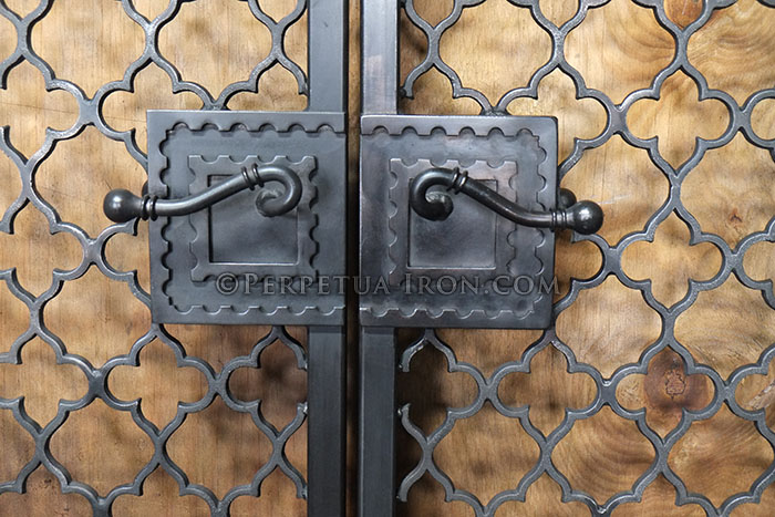 Close up view of custom handles on iron gates.
