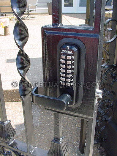 Detail shot of a mechanical digital lock for a garden gate with two columns of buttons.