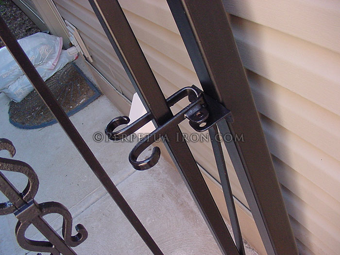 Locking spring latch for an iron gate.