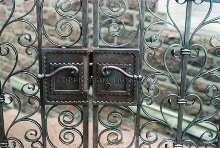 Custom locking handle on an iron gate.