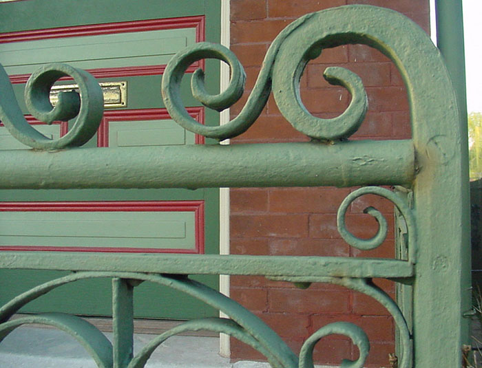 detail of 2.0 a rivetted iron porch railing.