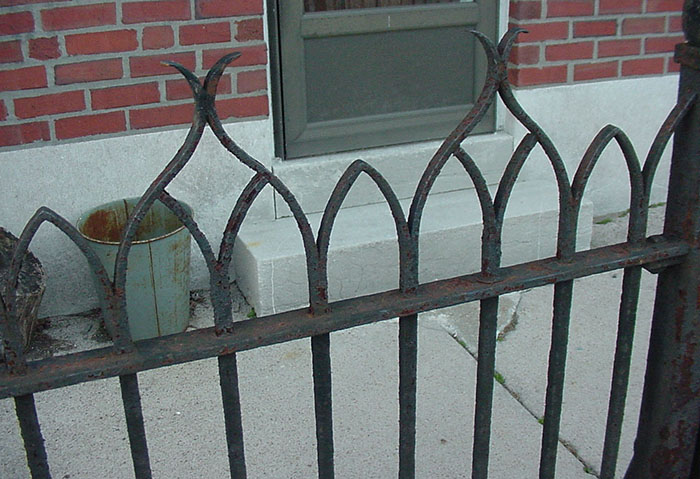 detail of 4.1, old railing in front of a house.
