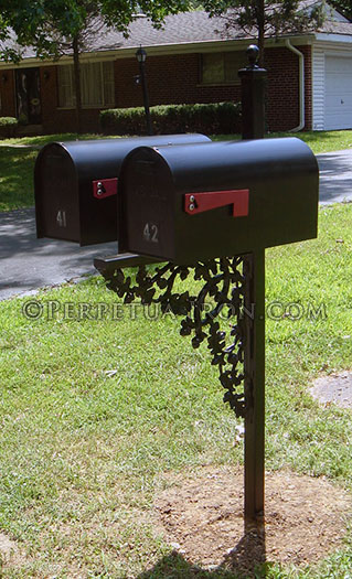 Double box mailbox post with cast iron components.
