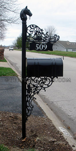 Ornametal iron mailbox post with cast iron horsehead finial.
