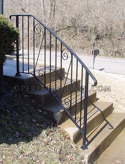 Exterior wrought iron handrail, curved, traditional design.