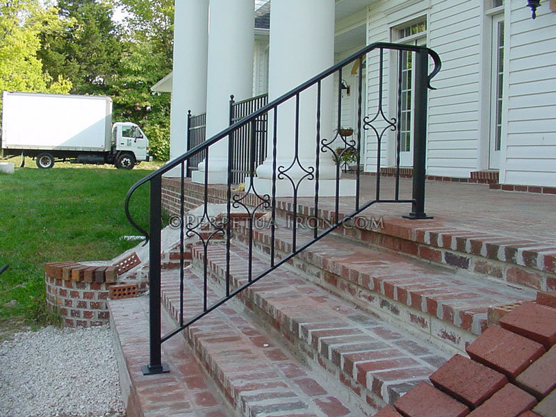 Stair railing with D shaped end that wraps back to the main posts.