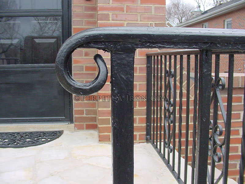 Hand forged simple scroll design on the end of a railing.
