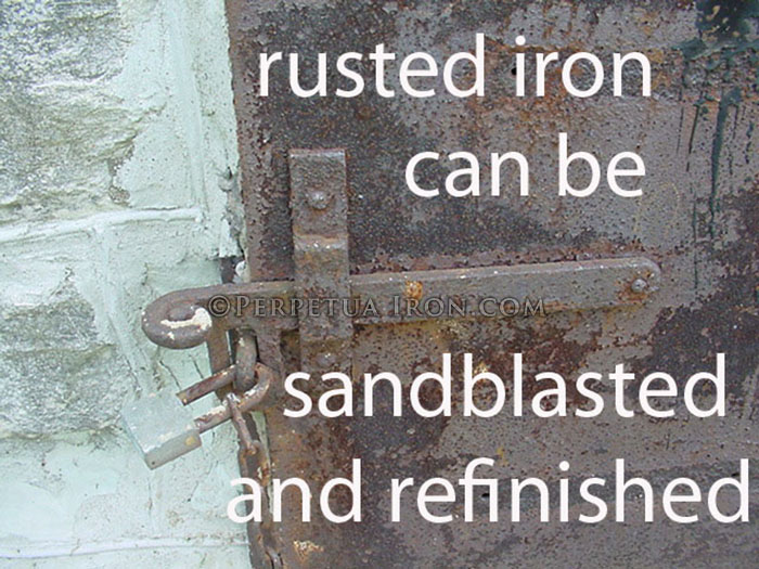 Solid steel door with heavy rust, detail shot of latch.