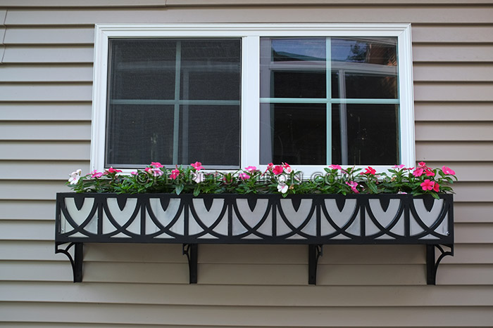 Laser cut window box with abstract pattern.